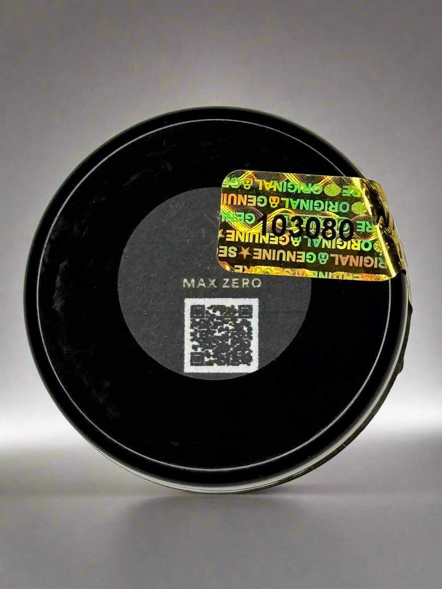 Black container with a yellow label and QR code on a gray background