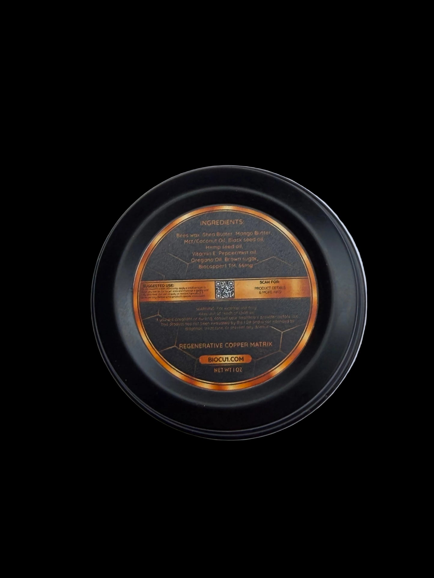 Round black container with gold and silver text on a light gray background